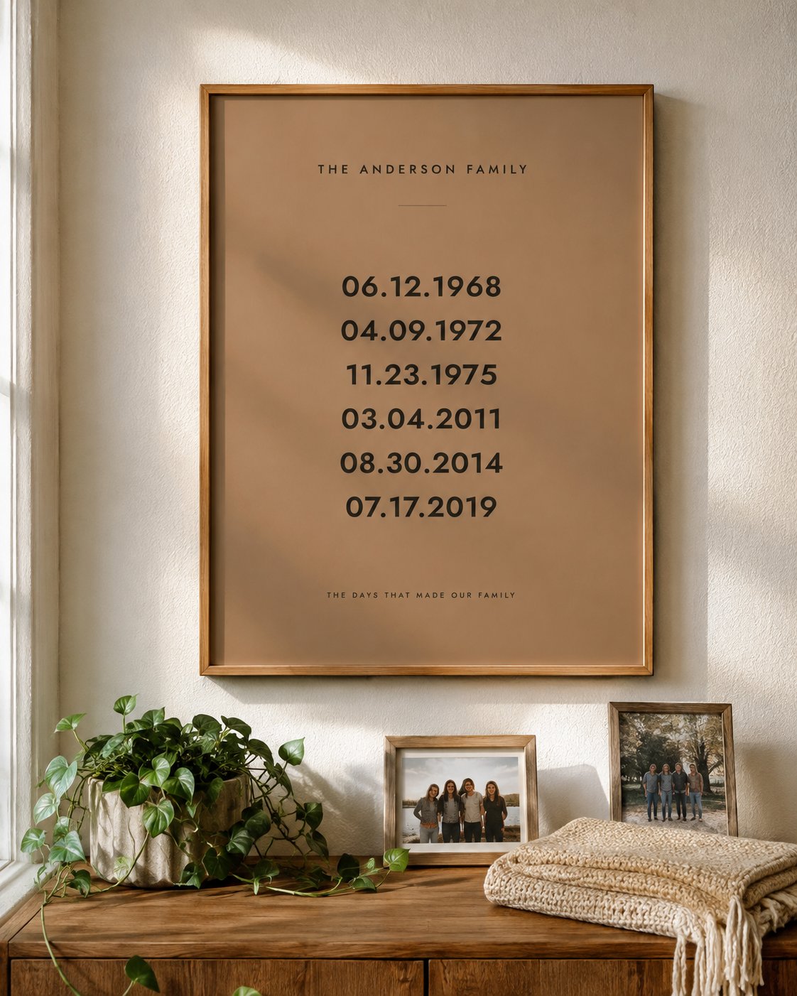 Personalized family dates wall art in a clay brown finish, framed in oak above a console table
