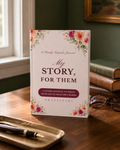 My Story, For Them guided journal standing on a walnut desk in warm window light