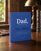 Dad, I Want to Hear Your Story guided journal standing on a walnut desk in warm window light