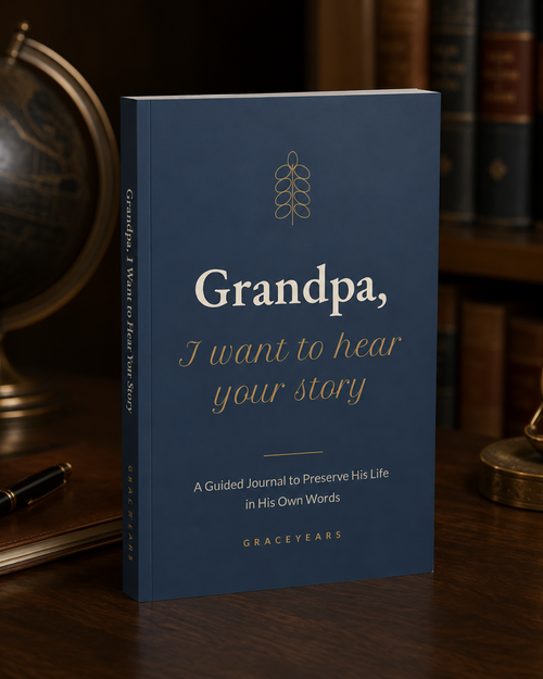 Grandpa, I Want to Hear Your Story guided journal standing on a wooden desk, navy softcover with gold lettering