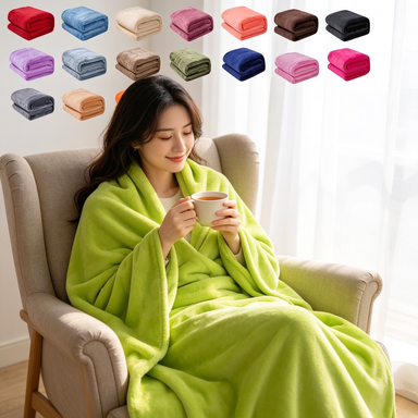 Woman wrapped in comfort throw blanket with tea