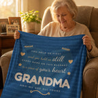 Grandmother holding a navy fleece blanket printed with her grandchildren's names in a heart