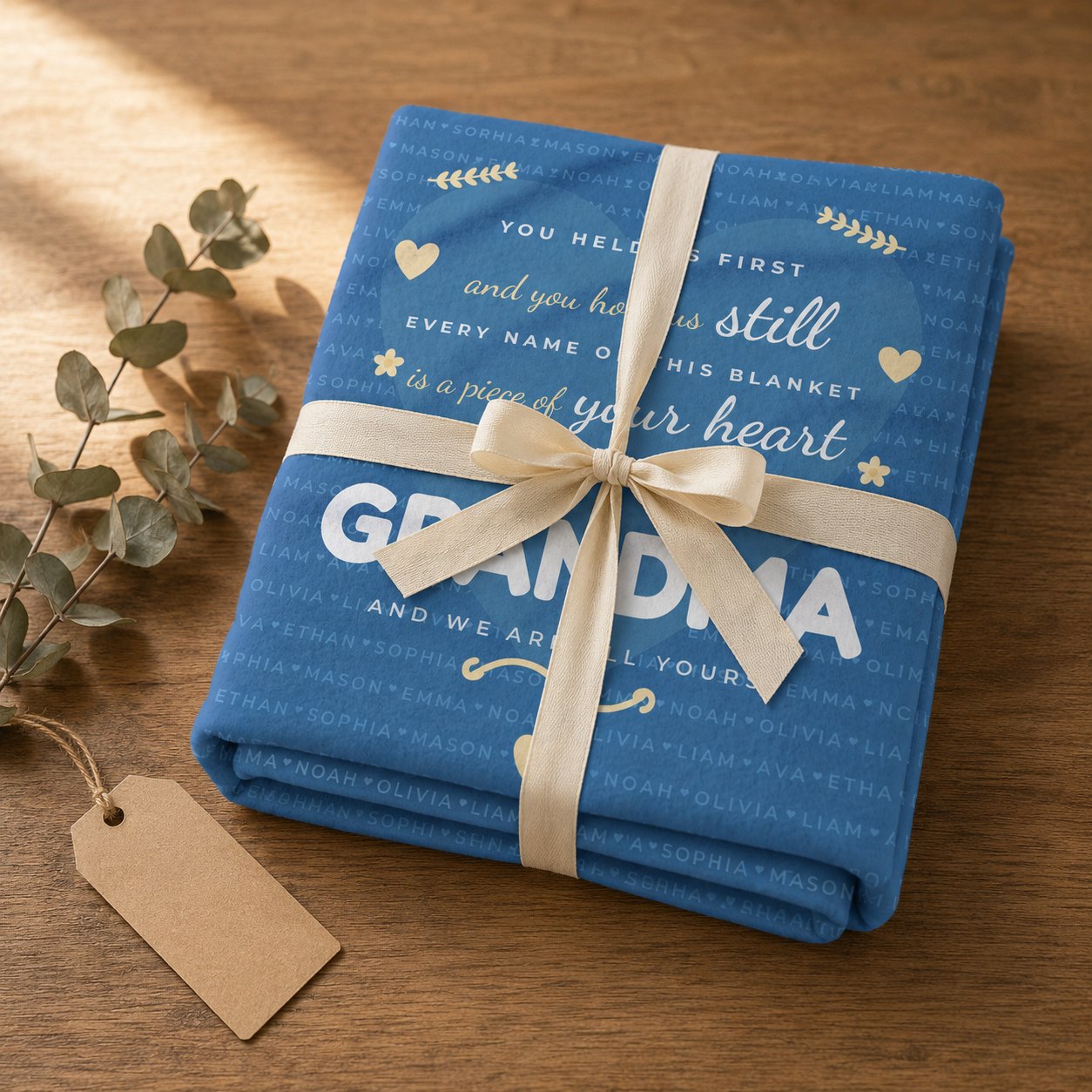 Personalized grandkids names blanket folded and tied with a cream ribbon as a gift
