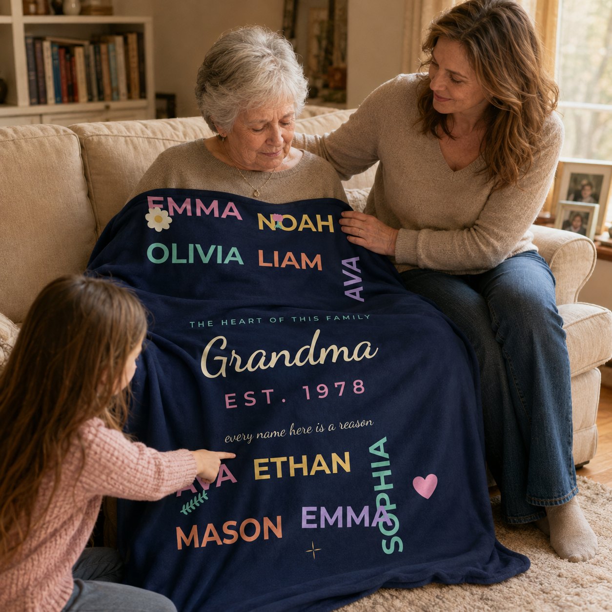 Three generations looking together at the personalized names blanket