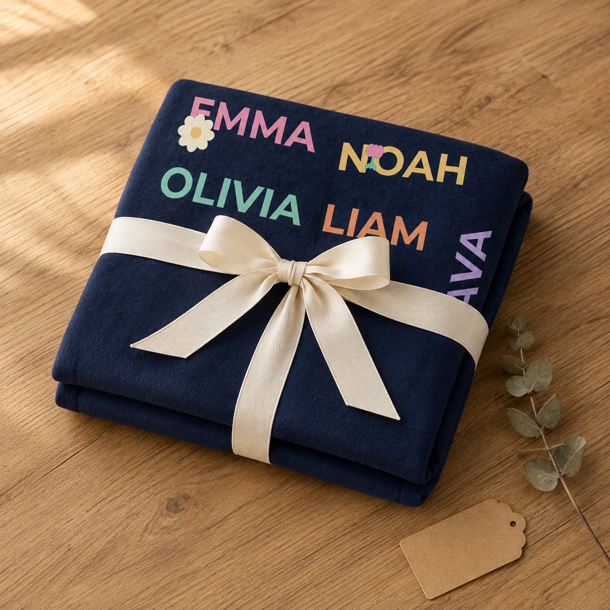 Personalized grandkids names blanket folded and tied with a cream ribbon as a gift
