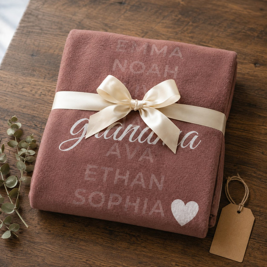 Personalized grandkids names blanket folded and tied with a cream ribbon as a gift