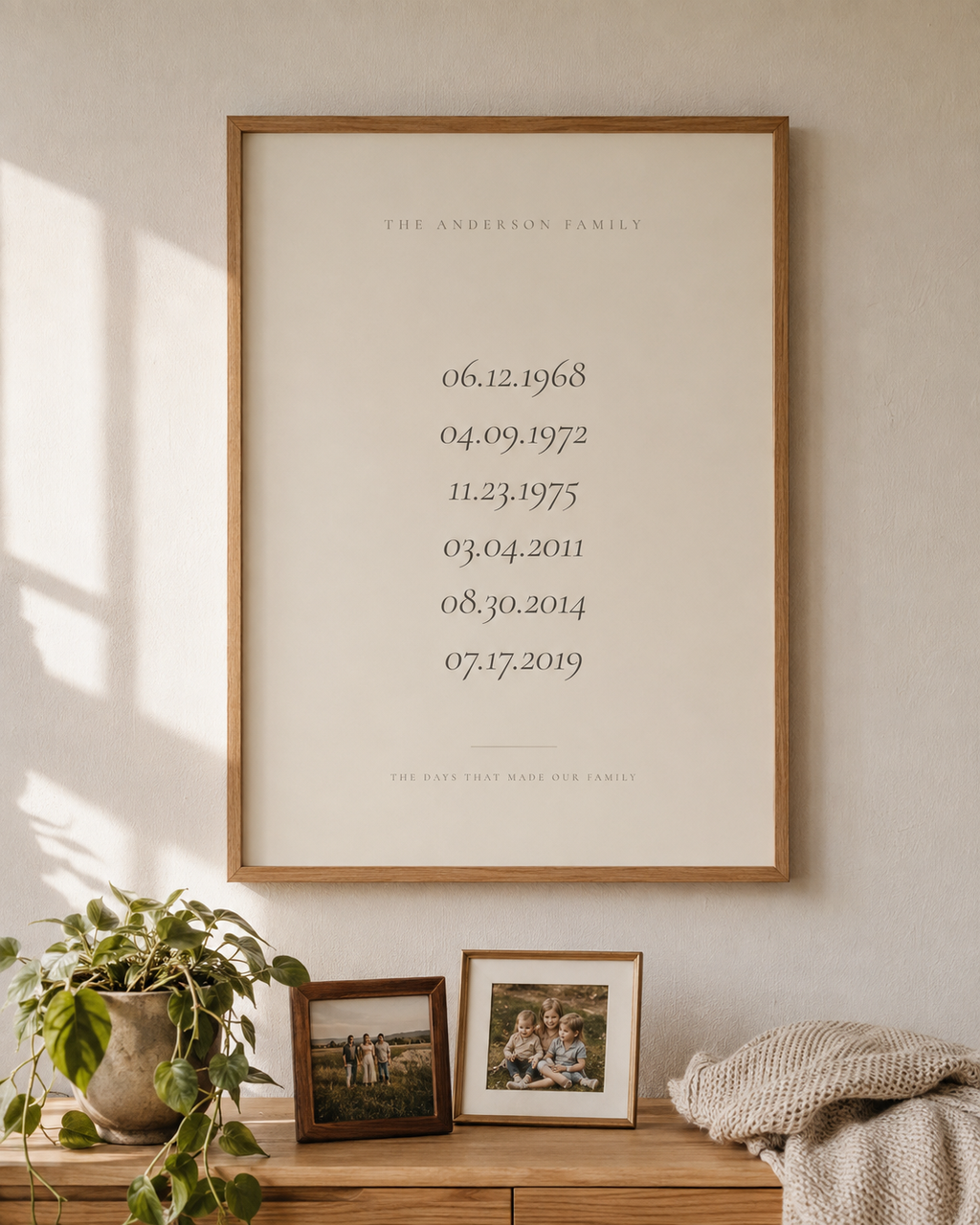 Personalized family dates wall art in Linen, framed in oak on a living room wall