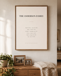 Personalized family dates wall art in Monogram, framed in oak on a living room wall