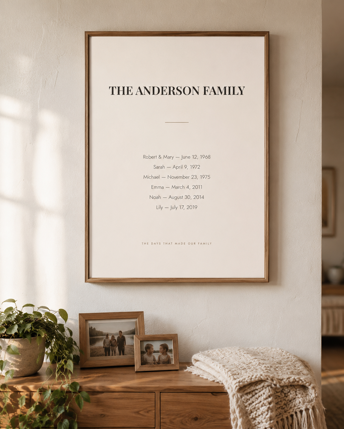 Personalized family dates wall art in Monogram, framed in oak on a living room wall